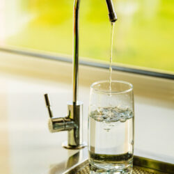 Water is drawn into a glass from a tap