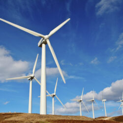 Wind turbines farm on sunset in winter